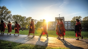Graduates walking across campus