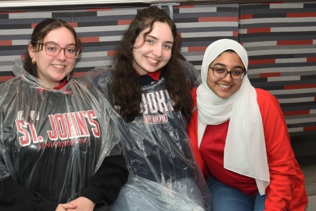 Three St. John's Students sitting inside to get out of the rain
