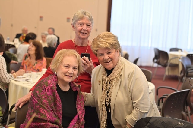 Three female alumna sitting at a table at the St. John's Retiree Lunch