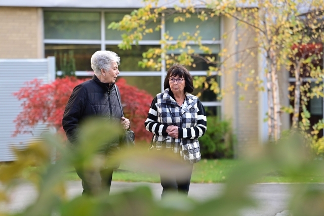 Two females walking on the St. John's Campus