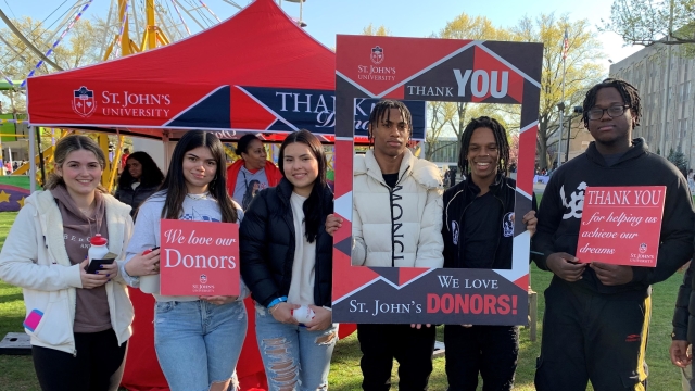 St. John's students holding Thank You signs for donors